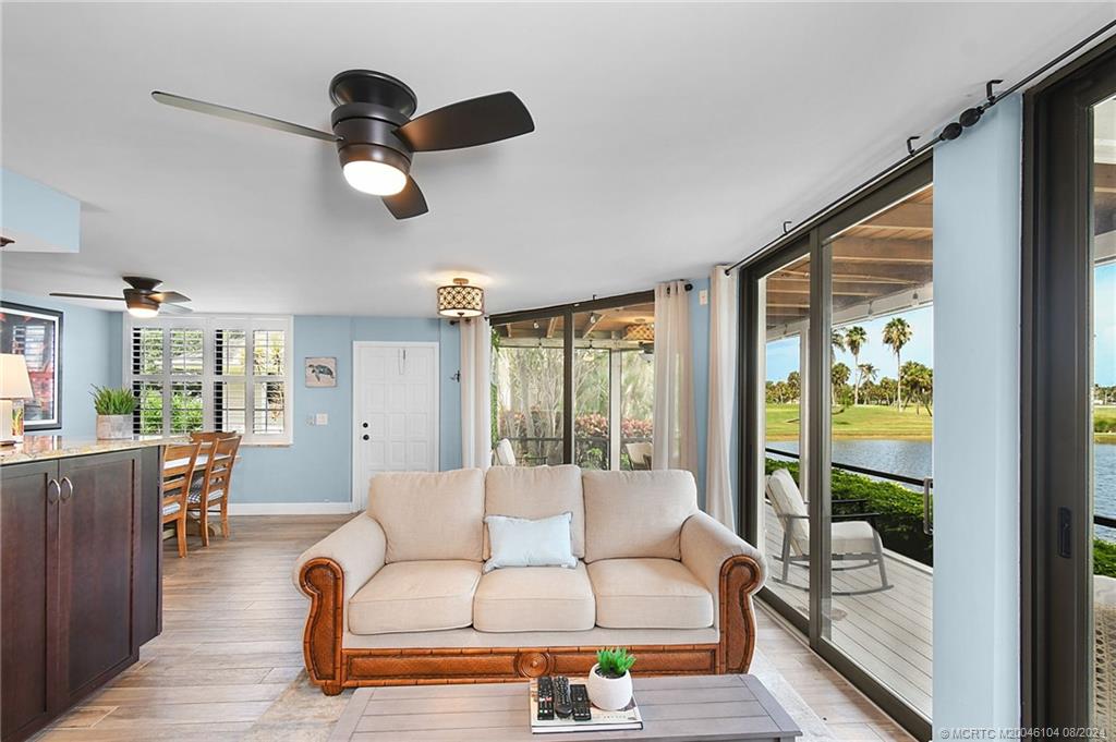 311 Golfview Circle Stuart, FL 34996 - Photo 7 of 37 a living room with furniture and a large window