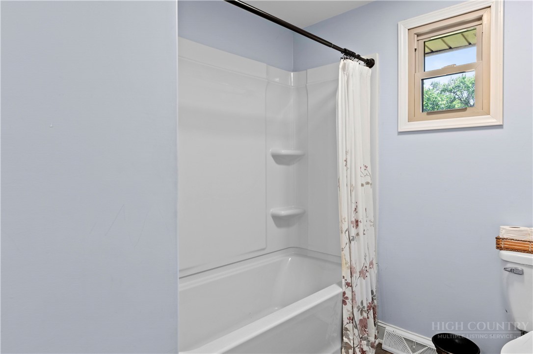 142 Pioneer Road Harmony, NC 28634 - Photo 40 of 49 a bathroom with a bathtub and a shower