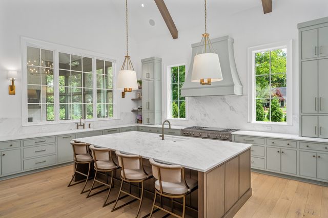 a stove top oven sitting inside of a kitchen