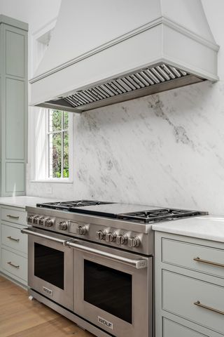 a bathroom with a granite countertop sink and a window