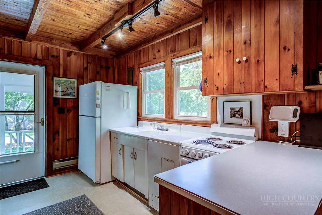 1010 Rash Road Glade Valley, NC 28627 - Photo 18 of 50 a kitchen with stainless steel appliances granite countertop a refrigerator and a stove top oven