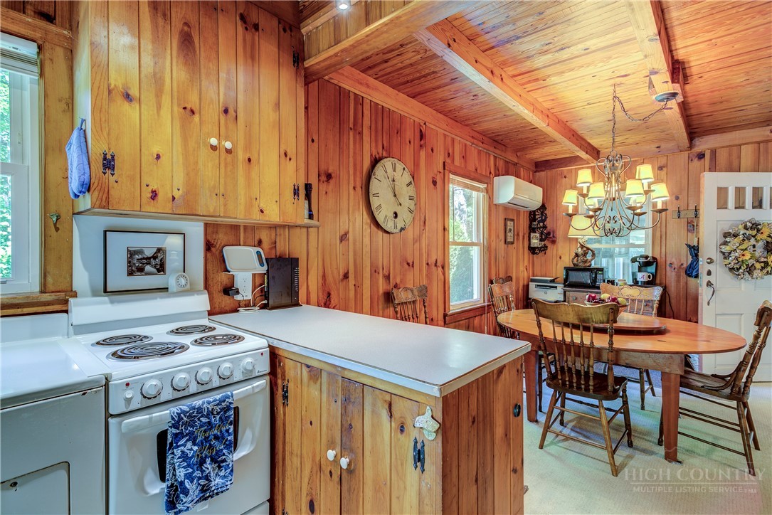 1010 Rash Road Glade Valley, NC 28627 - Photo 19 of 50 a kitchen with a stove a table and chairs