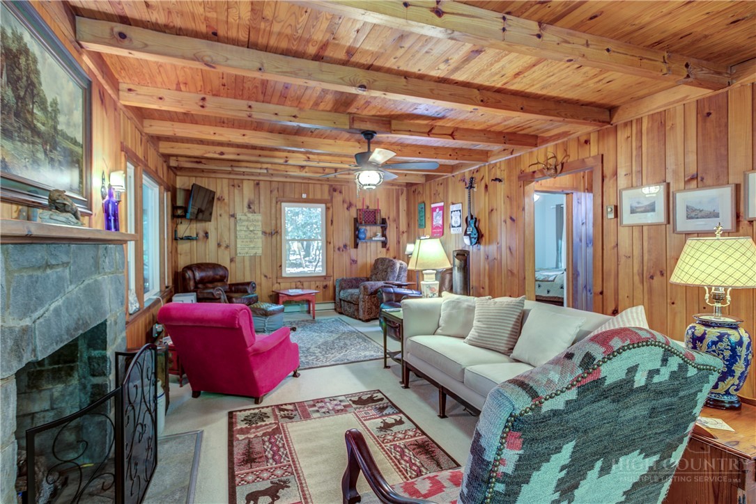 1010 Rash Road Glade Valley, NC 28627 - Photo 23 of 50 a living room with furniture and a chandelier