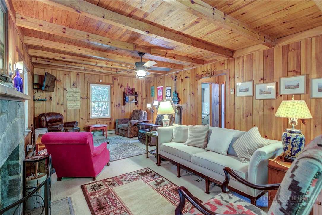 1010 Rash Road Glade Valley, NC 28627 - Photo 28 of 50 a living room with furniture and a chandelier
