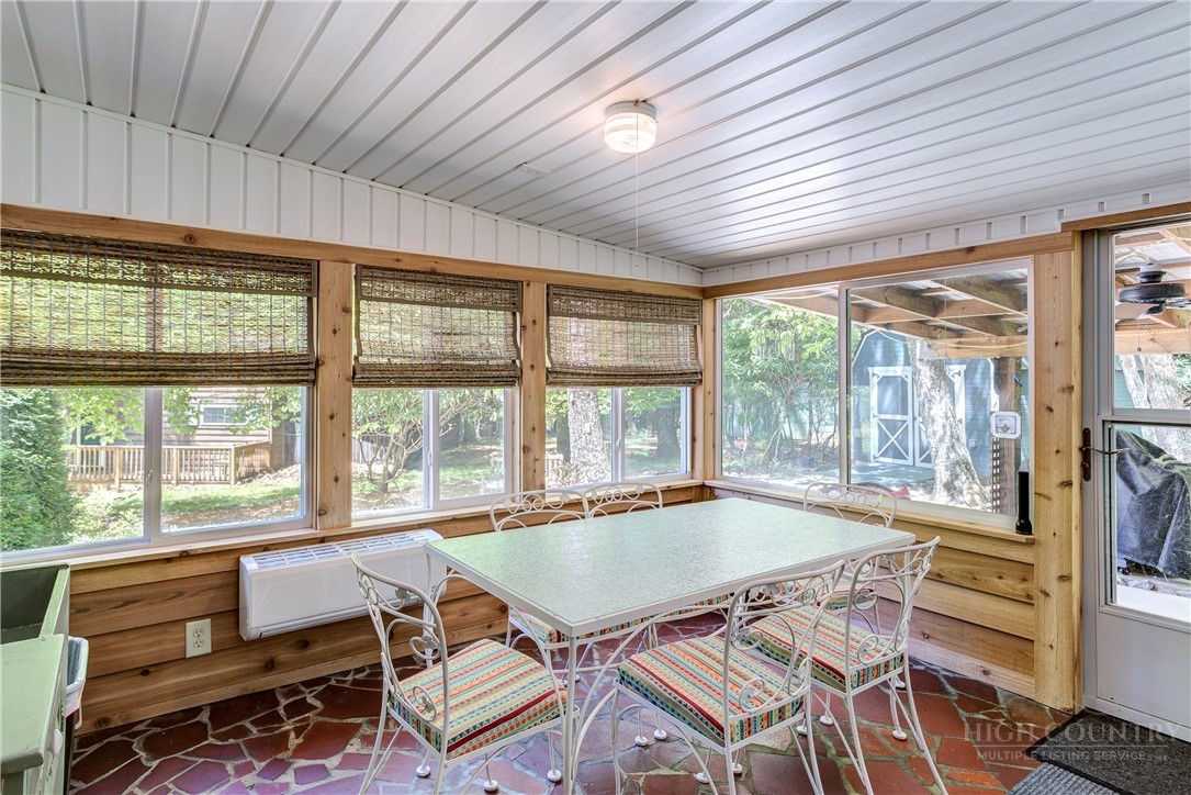 1010 Rash Road Glade Valley, NC 28627 - Photo 33 of 50 a view of a dining room with furniture large windows and wooden floor