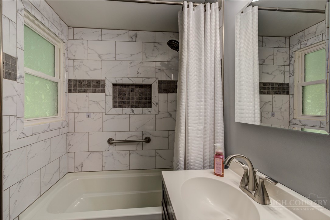 1010 Rash Road Glade Valley, NC 28627 - Photo 40 of 50 a bathroom with a sink and a shower