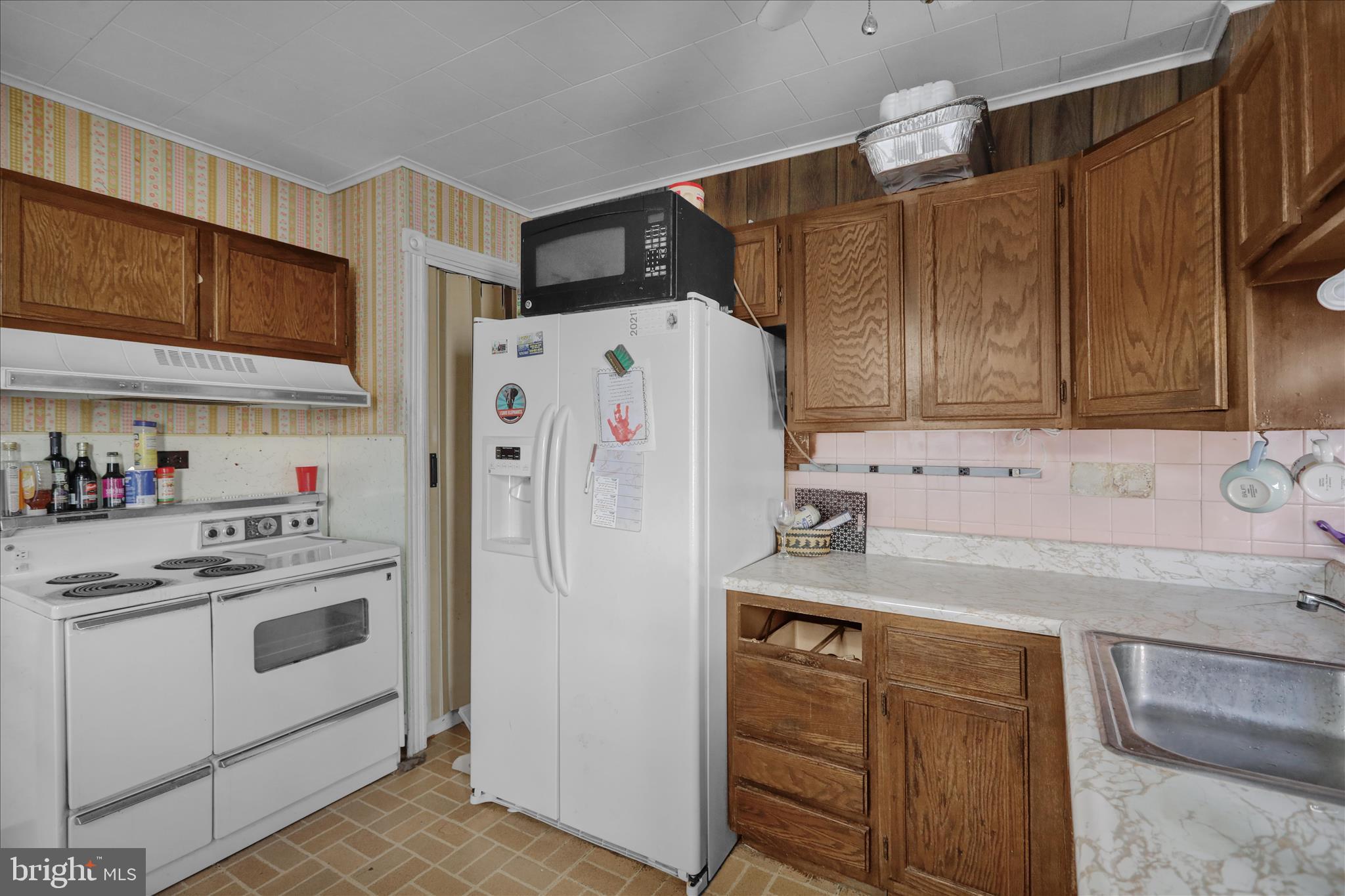 1217 Windsor Street Reading, PA 19604 - Photo 13 of 38 a white refrigerator freezer sitting inside of a kitchen