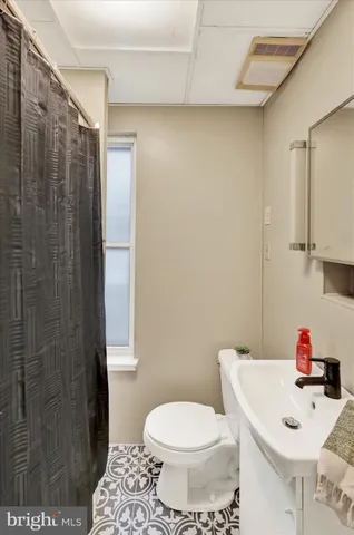 a white toilet sitting next to a bathroom sink