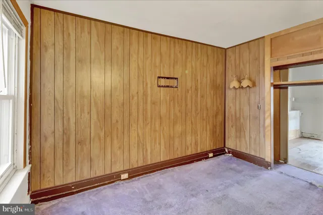 a view of a hallway with wooden floor and closet