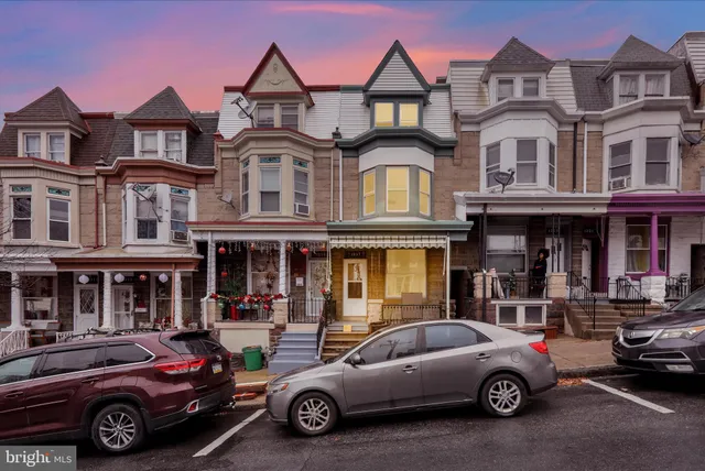 a front view of a residential apartment building with a yard