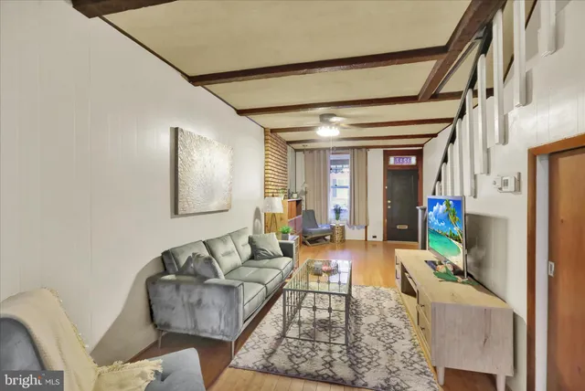 a living room with furniture and a flat screen tv