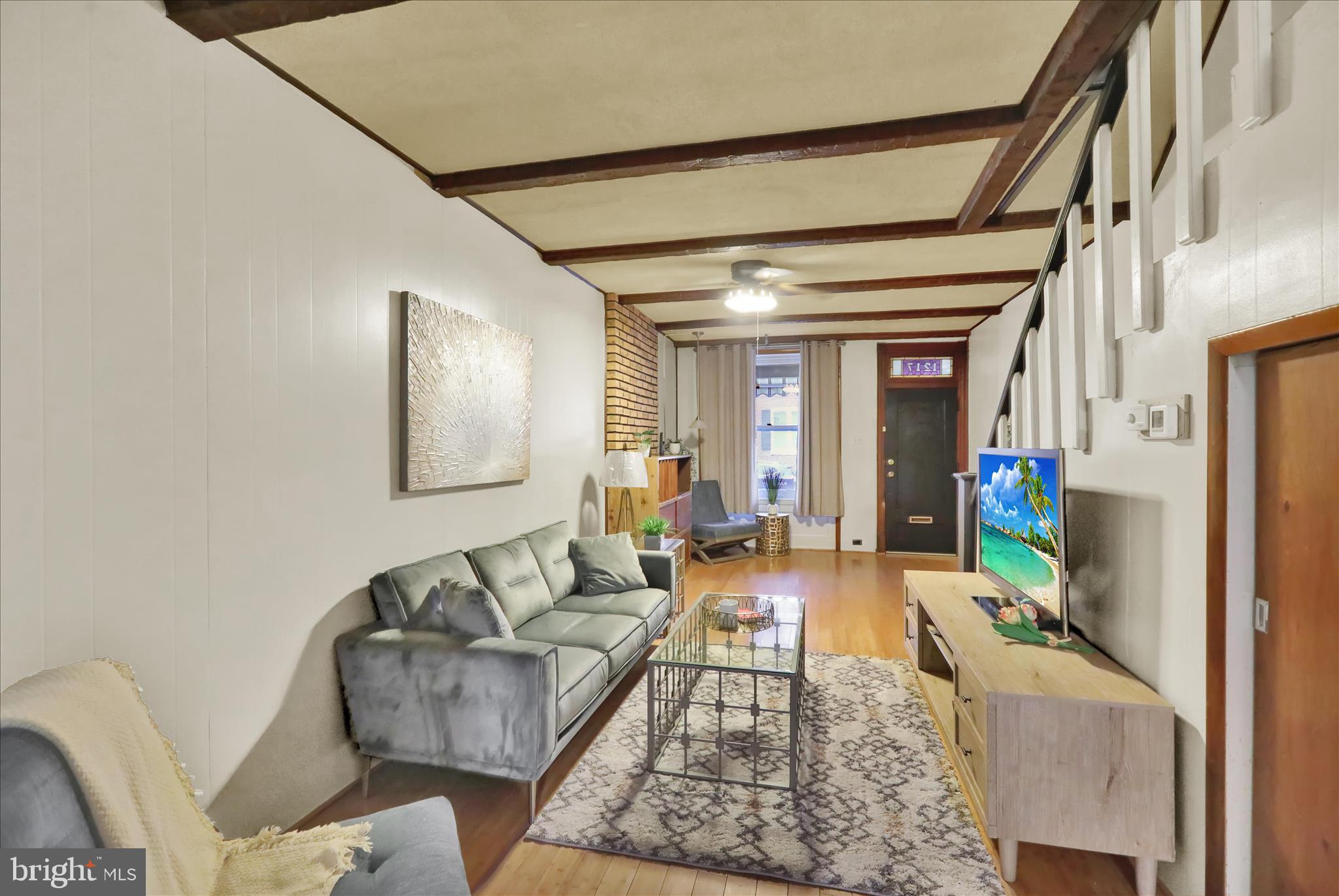 1217 Windsor Street Reading, PA 19604 - Photo 4 of 38 a living room with furniture and a flat screen tv