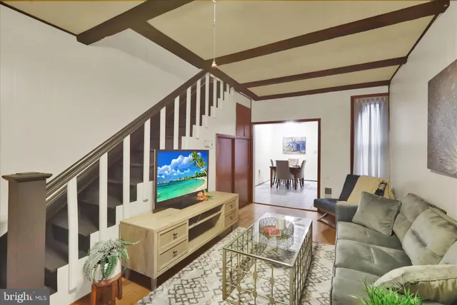 a living room with furniture and a flat screen tv