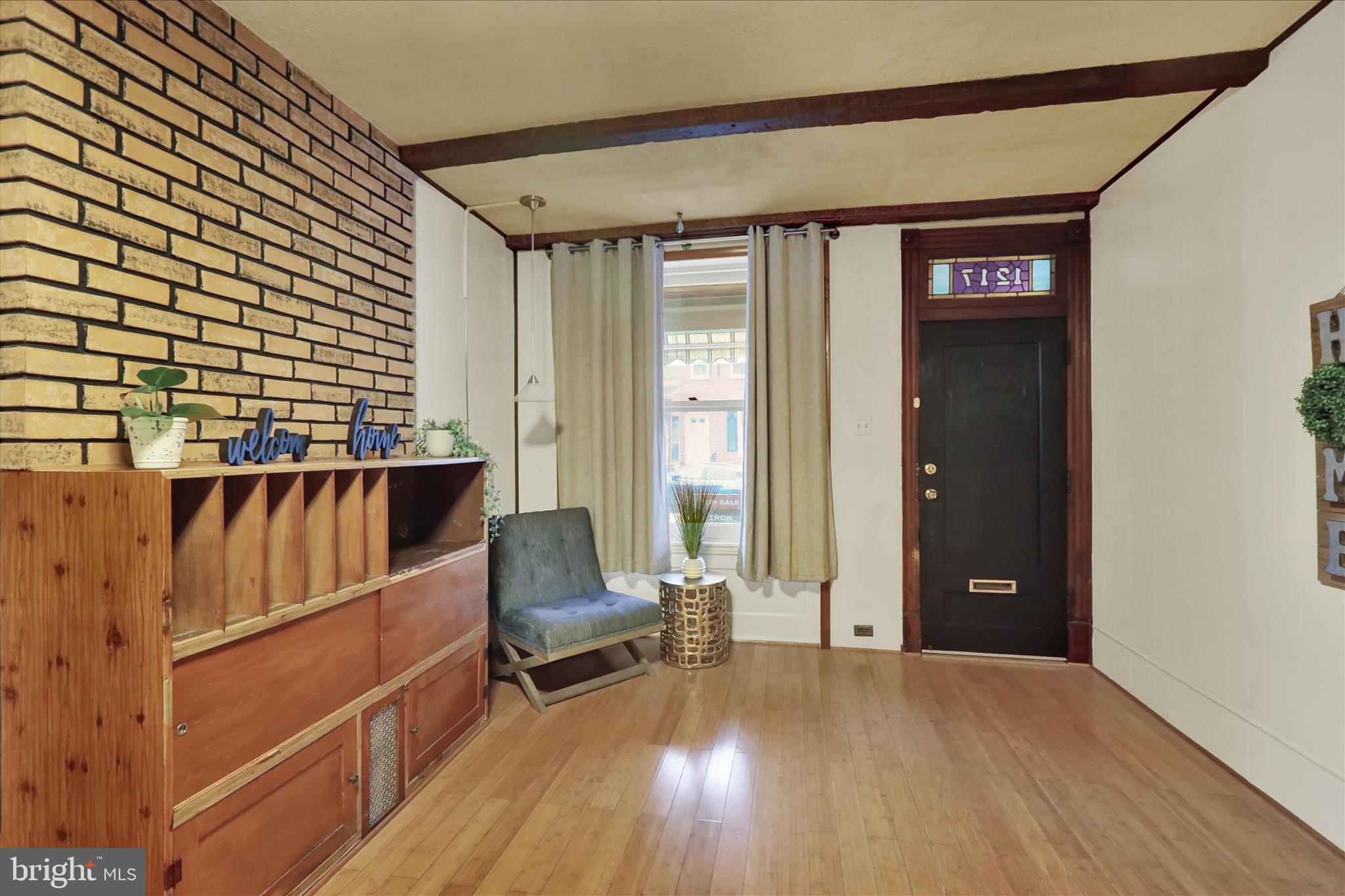 1217 Windsor Street Reading, PA 19604 - Photo 8 of 38 a view of front door with furniture and wooden floor