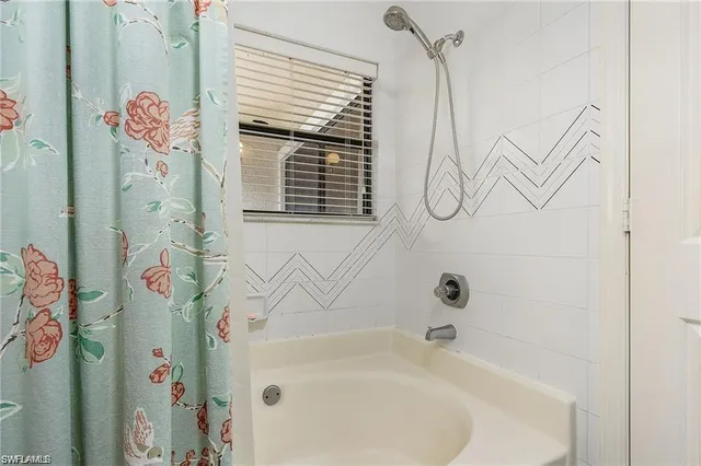a bathroom with a bathtub and shower curtain