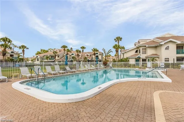 a view of a swimming pool with outdoor seating