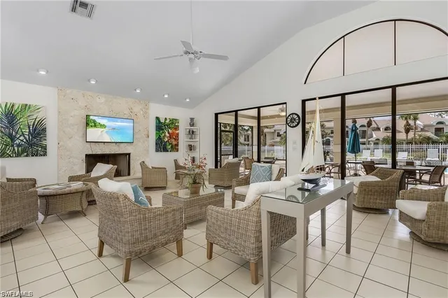 a living room with fireplace furniture and floor to ceiling window