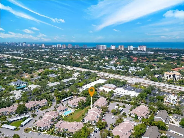 an aerial view of residential houses with city view