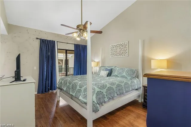 a bedroom with a large bed chandelier and a window