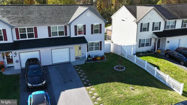 an aerial view of a house with swimming pool garden and patio