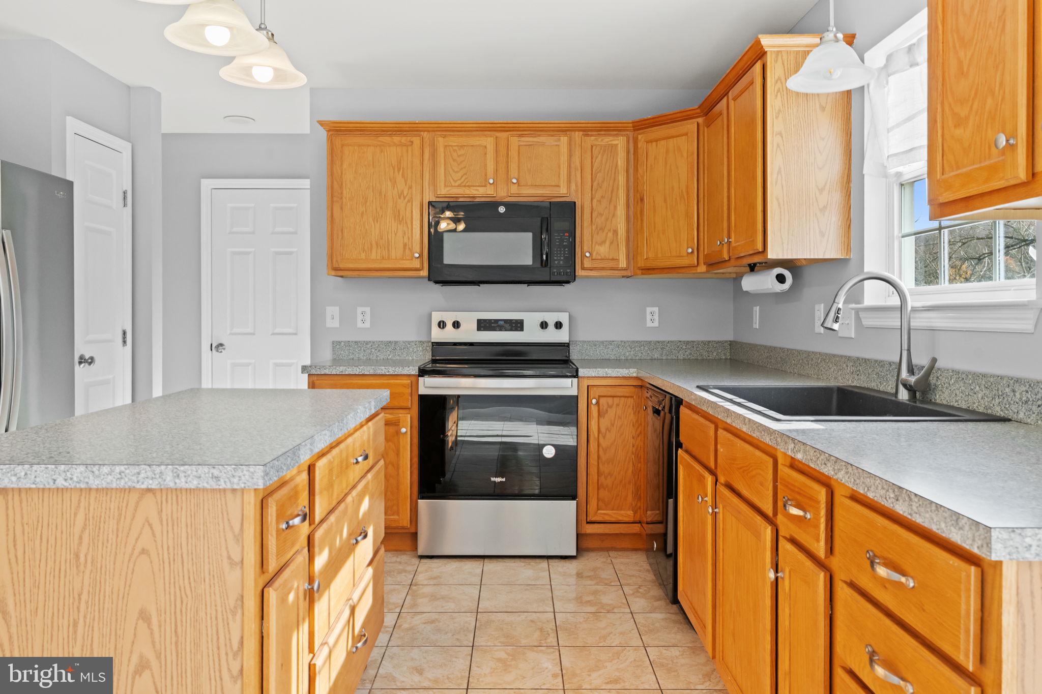 1014 Daisy Drive Temple, PA 19560 - Photo 19 of 83 a kitchen with stainless steel appliances granite countertop a sink stove and refrigerator