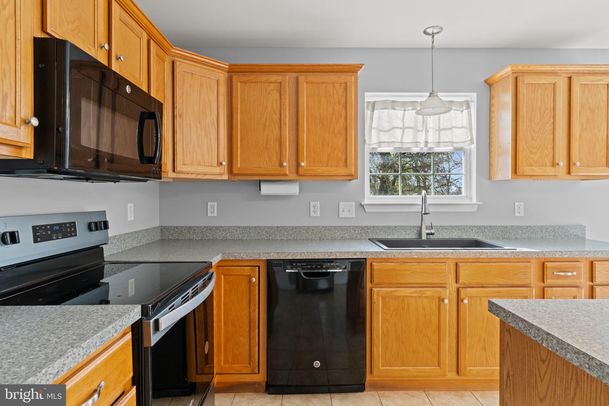 1014 Daisy Drive Temple, PA 19560 - Photo 21 of 83 a kitchen with a sink stove top oven and cabinets