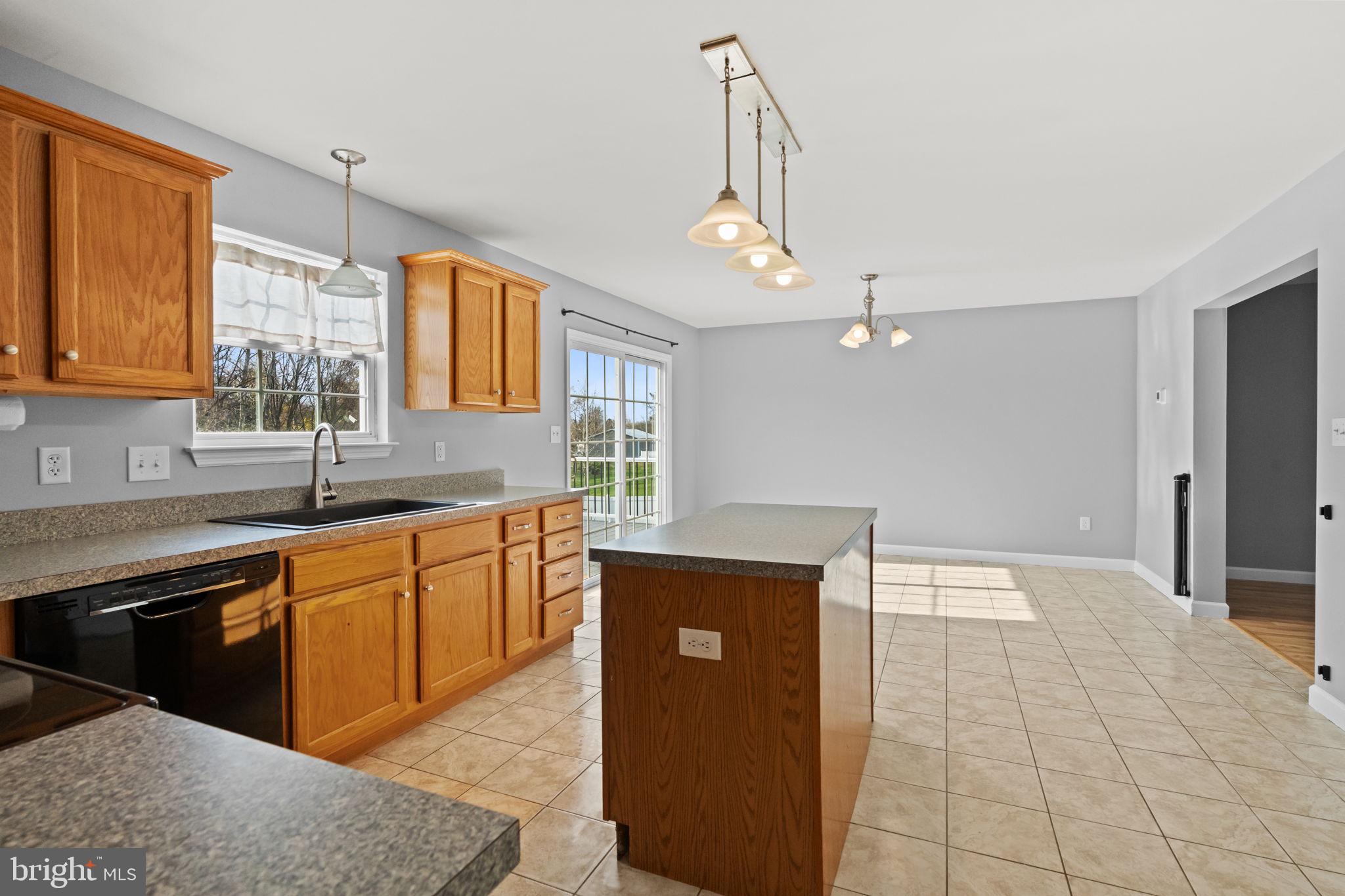 1014 Daisy Drive Temple, PA 19560 - Photo 23 of 83 a kitchen with stainless steel appliances granite countertop a sink and a stove