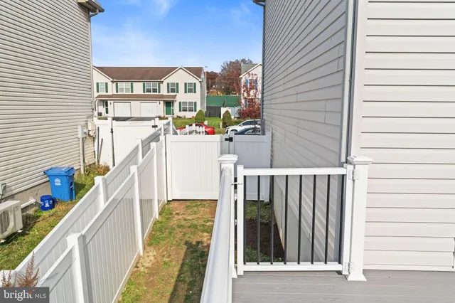 a spacious bathroom with a granite countertop sink a toilet and a large mirror