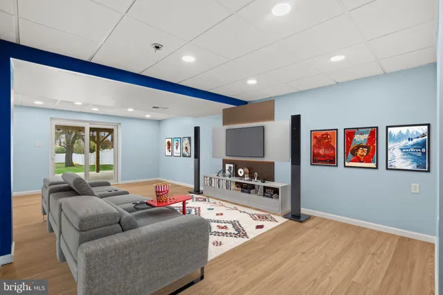 a view of an empty room with a chandelier fan