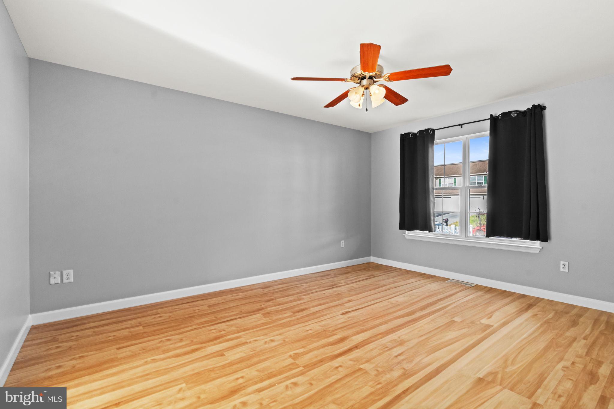1014 Daisy Drive Temple, PA 19560 - Photo 7 of 83 a view of an empty room with wooden floor and a window