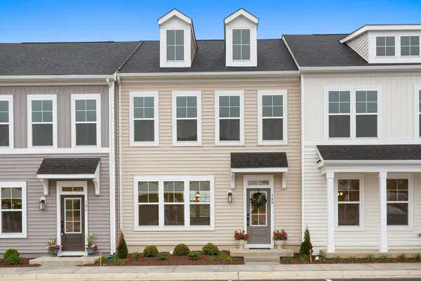 a front view of a building with a garden