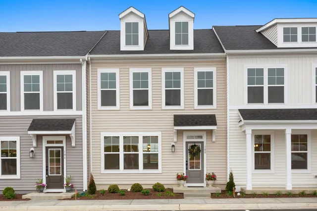 a front view of a building with a garden