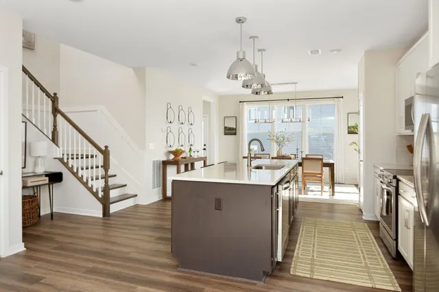 a view of a room with wooden floor and staircase