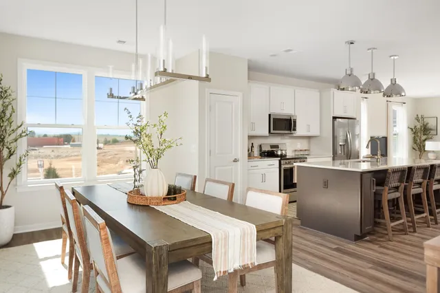 a kitchen with kitchen island a large counter top space appliances and cabinets