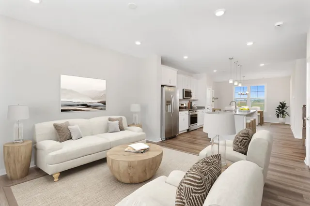a living room with furniture and kitchen view