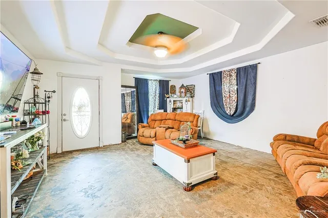 a living room with furniture a rug and a window