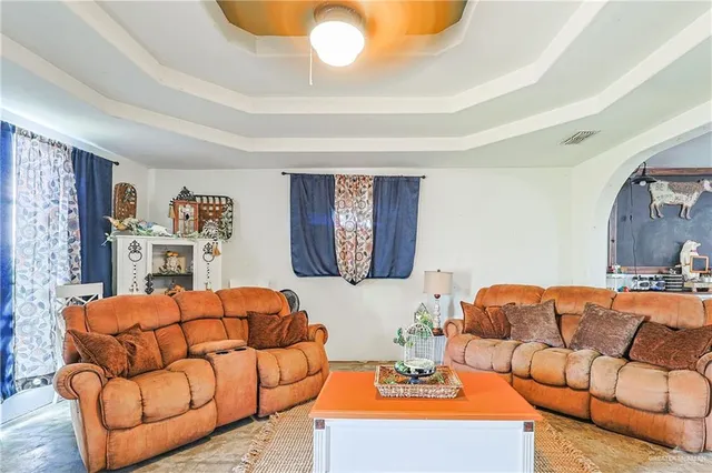 a living room with furniture and a lamp