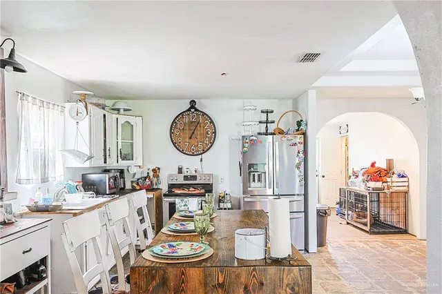 a dining room with wooden floor and chandelier