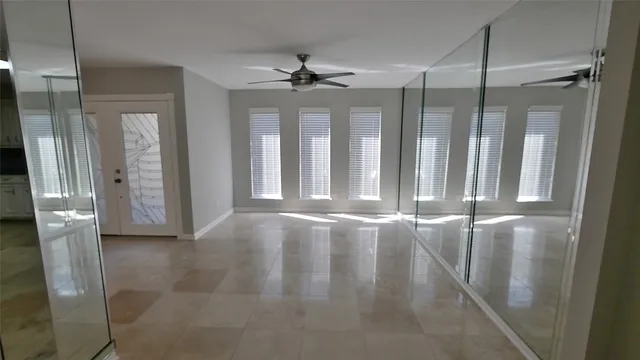 a view of a hallway with entryway and kitchen view