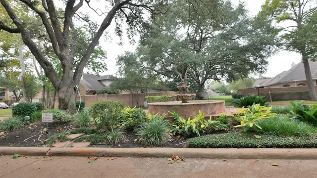 a backyard of a house with a garage and outdoor seating