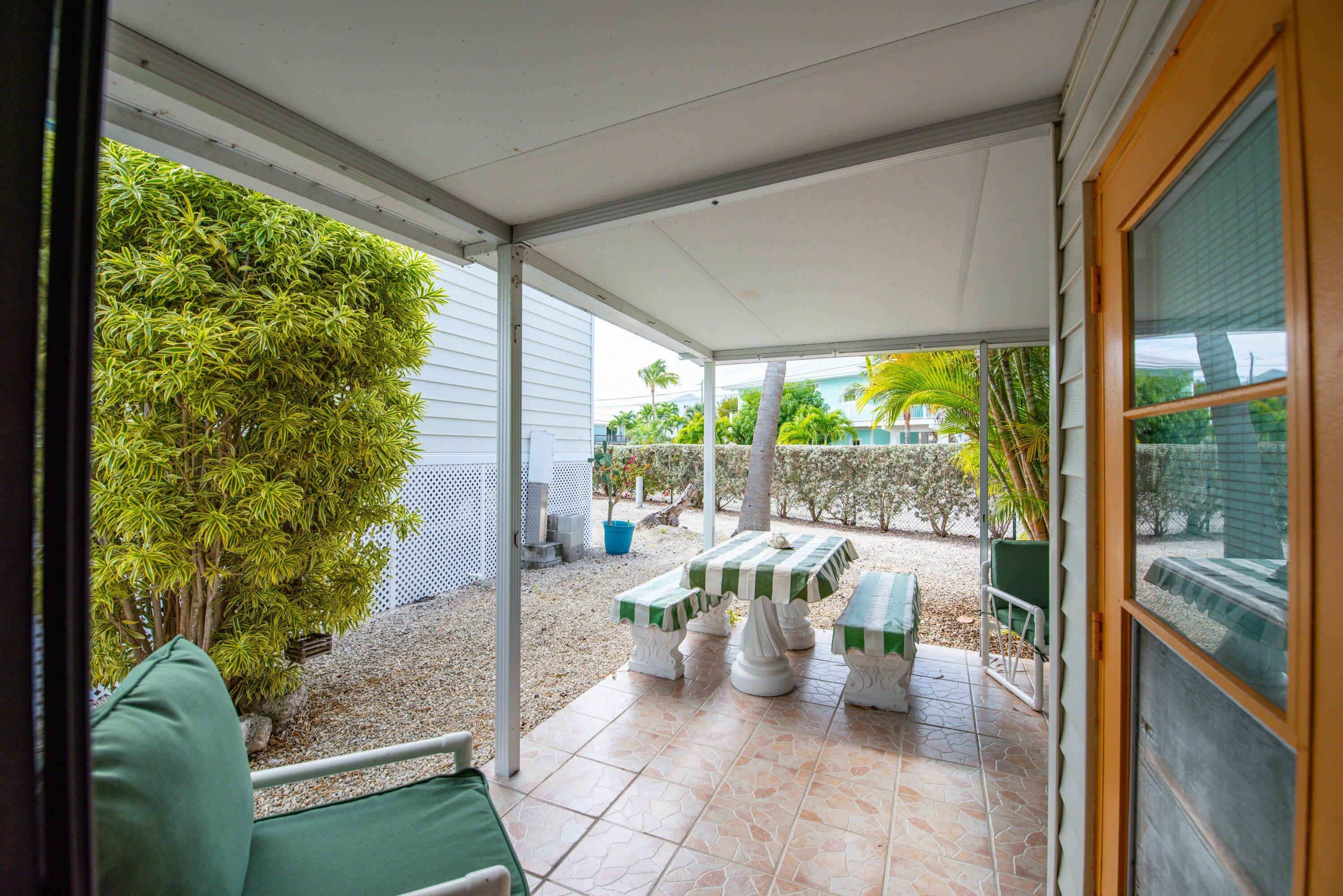 701 Spanish Main Drive, Unit 21 Cudjoe, FL 33042 - Photo 19 of 49 a view of a porch with chairs and backyard