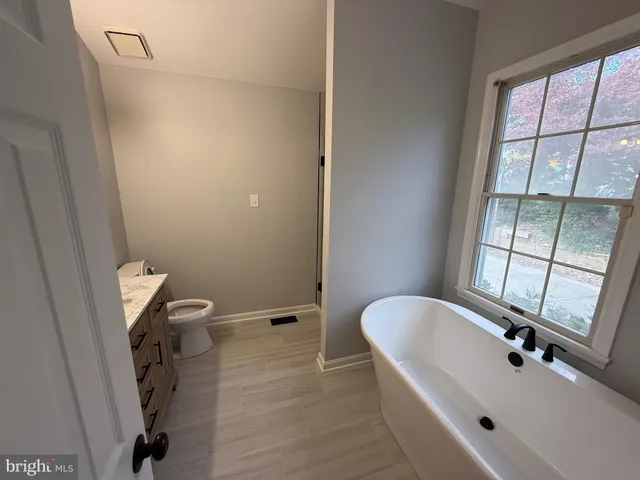a bathroom with a sink a toilet and a tub