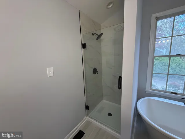 a bathroom with a tub and shower