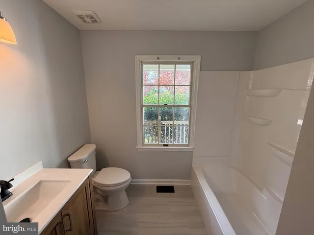 a bathroom with a toilet a sink and a bathtub