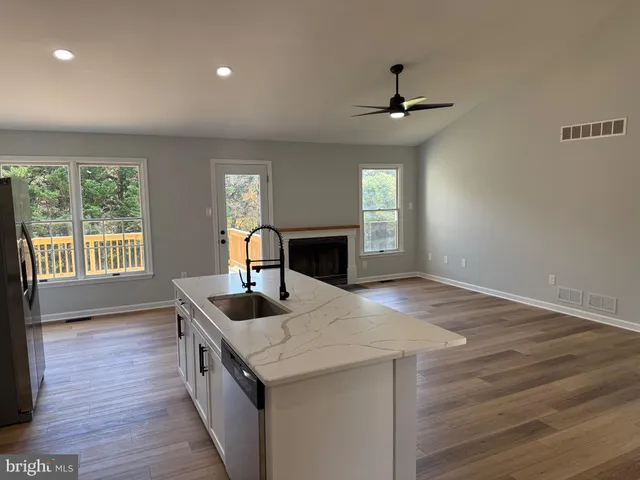 a kitchen with granite countertop a sink and a stove
