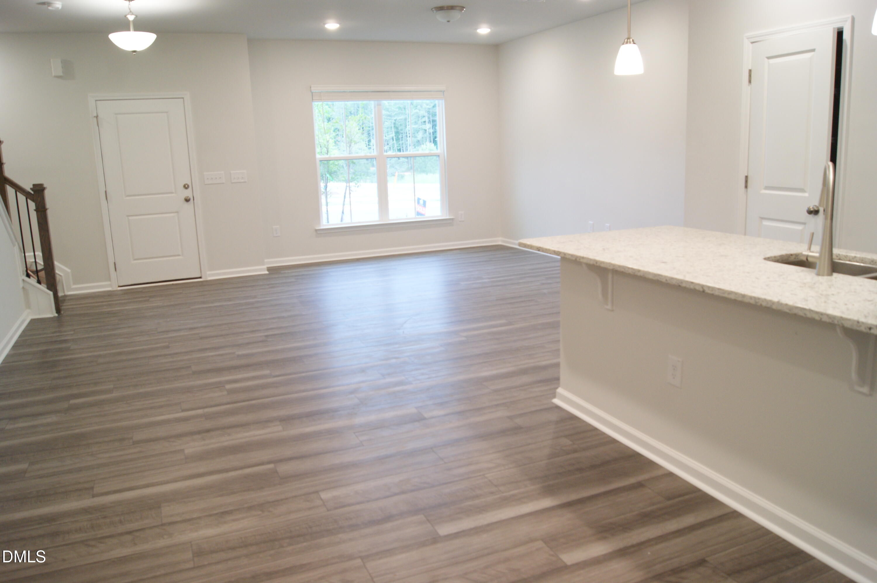 295 Glenmore Gardens Road Raleigh, NC 27603 - Photo 2 of 30 a view of an empty room with wooden floor and a window