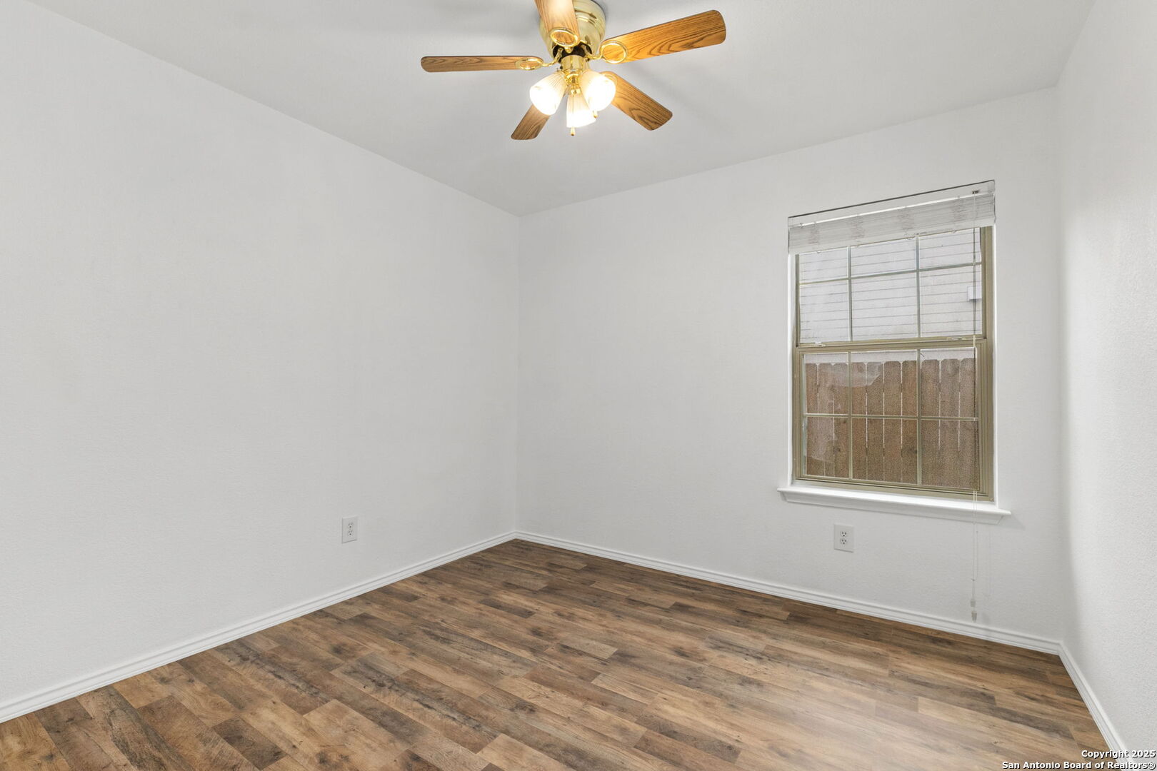 620 Waterleaf Boulevard Kyle, TX 78640 - Photo 27 of 34 an empty room with a window and a fan