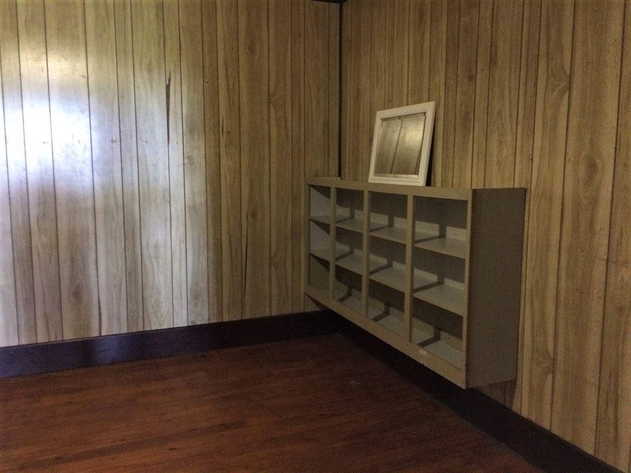 109 Cascade Hollow Road Normandy, TN 37360 - Photo 6 of 12 an empty room with wooden floor windows and cabinet