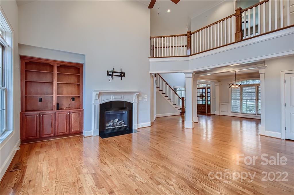 7653 Juniper Lane Denver, NC 28037 - Photo 5 of 28 a view of a livingroom with wooden floor and a fireplace