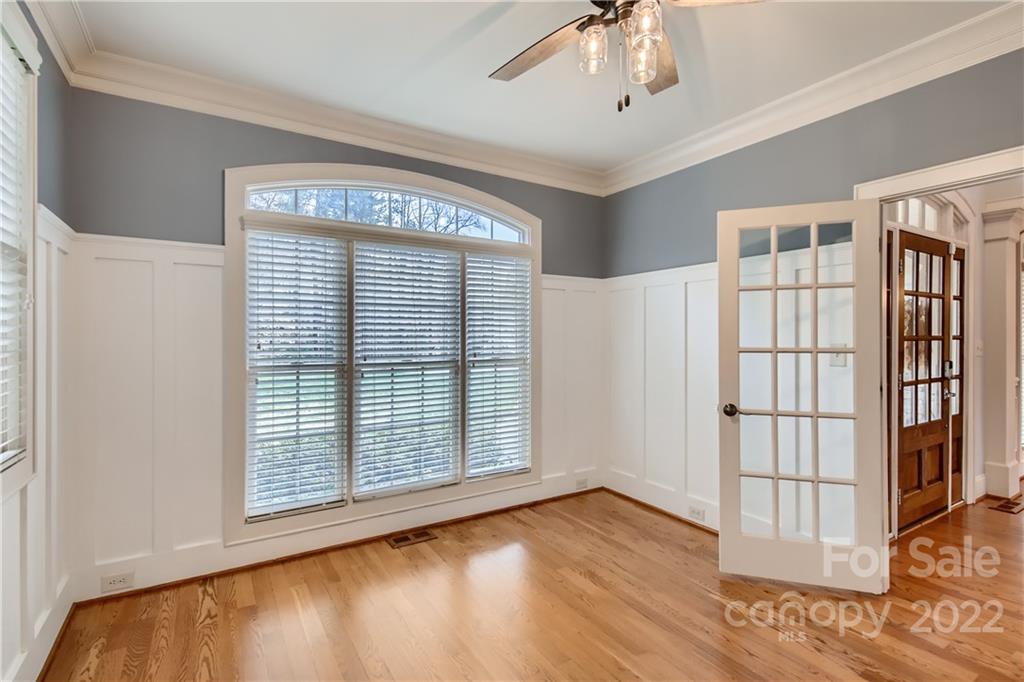 7653 Juniper Lane Denver, NC 28037 - Photo 7 of 28 a view of an empty room with wooden floor and a window
